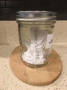 Image of the sealed Jargon Jar, containing papers inside with jargon buzzwords and phrases. Today's entry will be think outside the box.